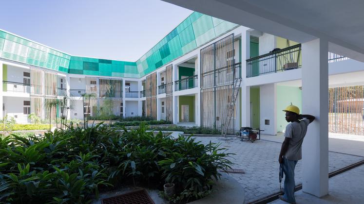 Photo of GHESKIO Tuberculosis Hospital, Photo by Iwan Baan, Process Photo of Construction Worker in Courtyard