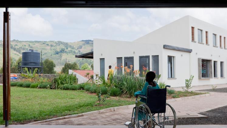 Photo of Butaro District Hospital, Photo by Iwan Baan, A patient looks out at the inner yard