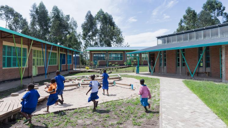 Photo of Mubuga Primary School, Photo by Iwan Baan, children playing in the inner yard of the school