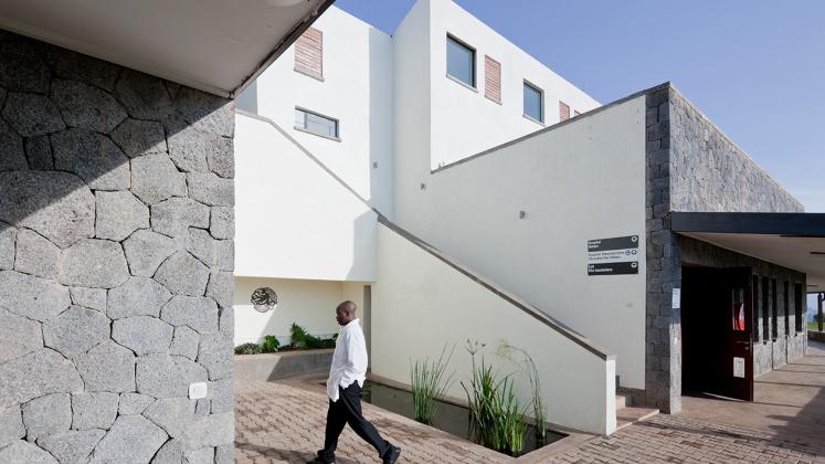 Photo of Butaro District Hospital, Photo by Iwan Baan, Exterior Staircase and Hallway with Doctor
