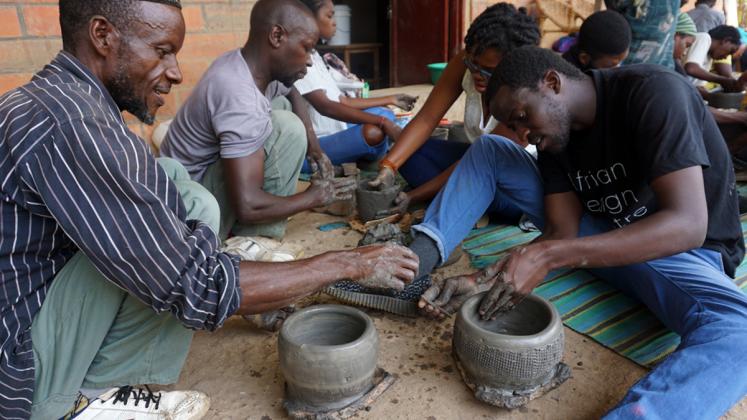 Photo: ADC fellows practicing traditional pottery techniques at Urukundu Village