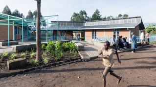 Photo of Mubuga Primary School, Photo by Iwan Baan, Exterior of the school building with children running past